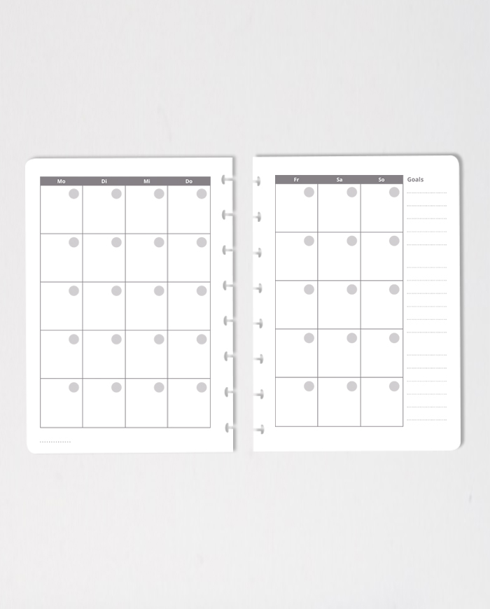 Set of erasable monthly calendar notebook pages on grey background