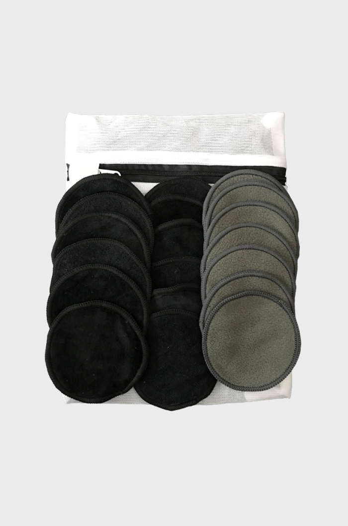 Sets of reusable bamboo make-up remover pads in grey and black on top of wash-bag