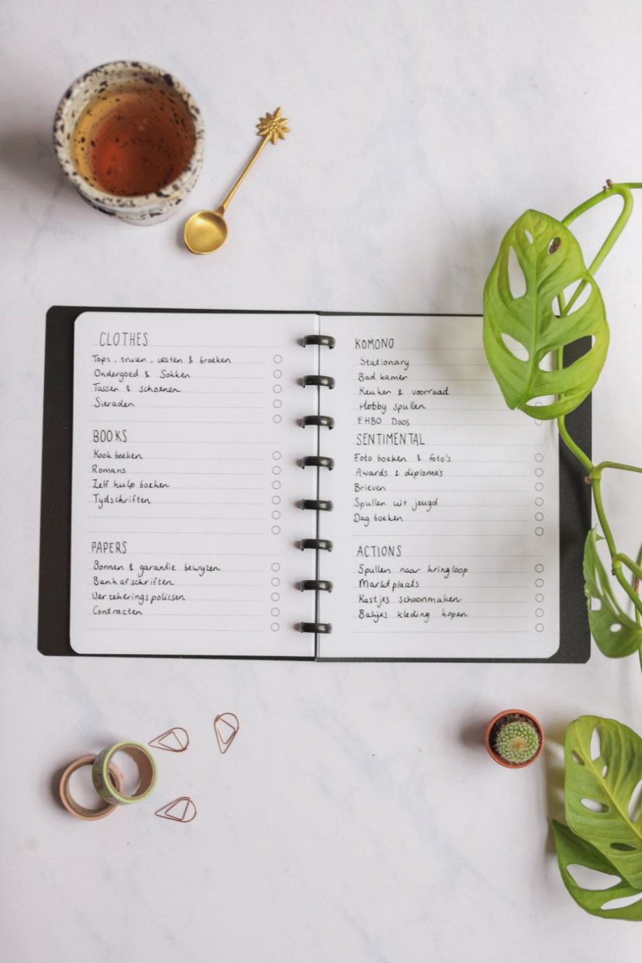 Erasable to-do list next to assorted items on marble background